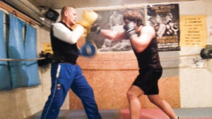 Bryan Gibson, left, doing what he's done for more than 40 years, teaching the sweet science of boxing at his gym in Kentville. (Contributed)